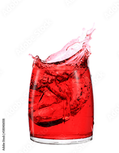 Splashes of red drink in transparent glass isolated on white background