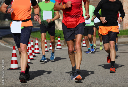 runners during the marathon on the city streets run in sneakers