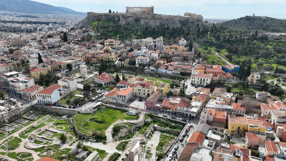 Aerial drone photo of iconic Acropolis hill and the Parthenon as seen from picturesque Plaka and Monastiraki districts - Roman forum, Athens historic centre, Attica, Greece