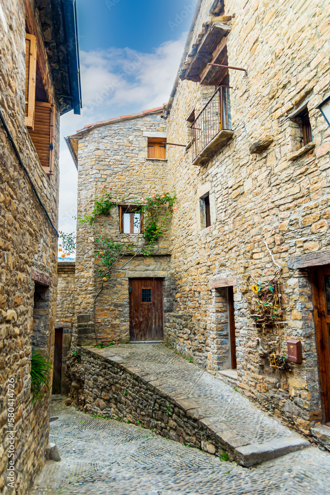 Picturesque urban landscape of cobblestone streets and rural houses in the village of Ainsa, Spain.