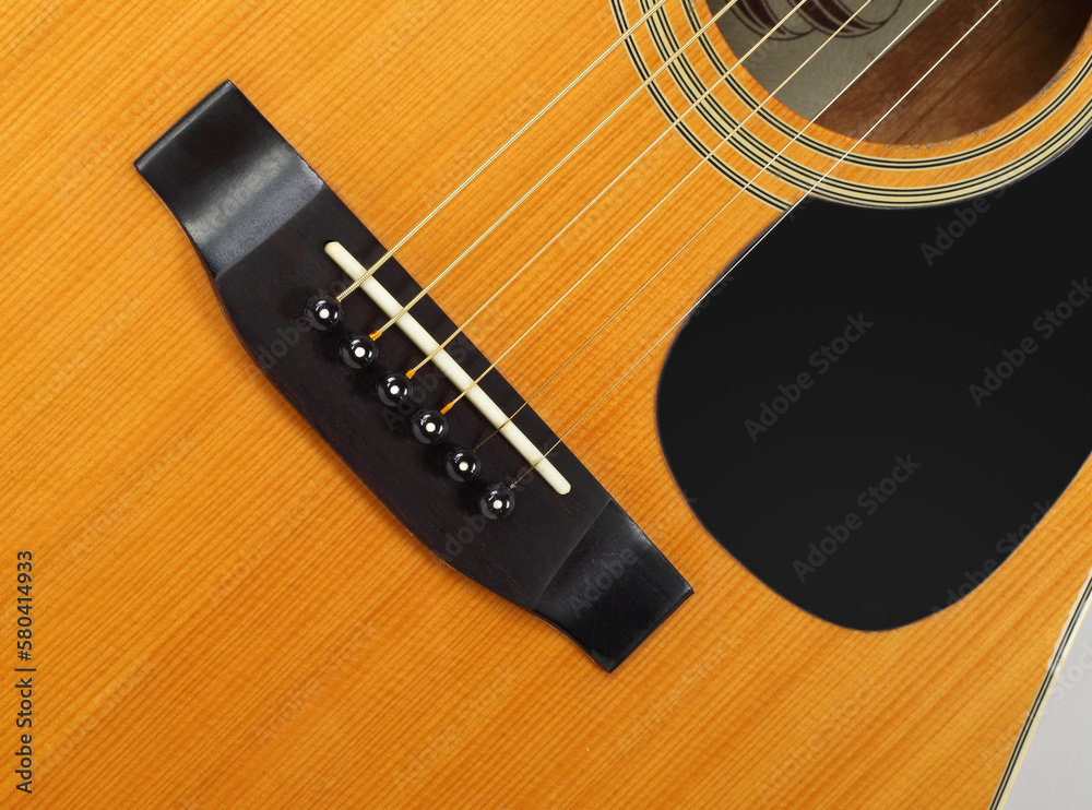 Fototapeta premium Musical instrument - Top view pickguard, bridge, pins and strings acoustic guitar