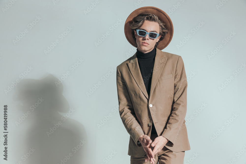 smart casual guy with blonde hair wearing beige suit and posing smart casual guy with blonde hair wearing beige suit and posing