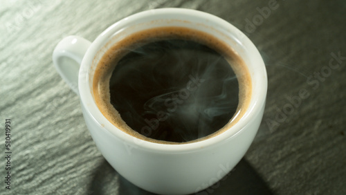 Macro Shot of Coffee Drop Falling into Fresh Espresso Cup