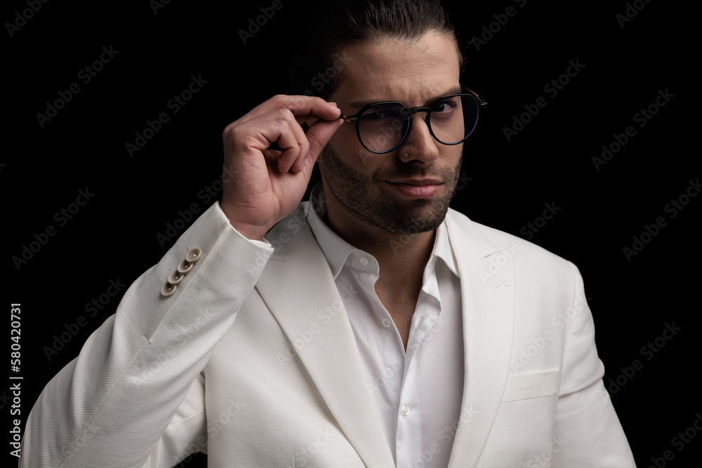 sexy elegant man in white suit smiling and adjusting glasses sexy elegant man in white suit smiling and adjusting glasses