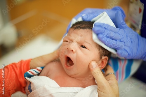 Newborn baby in NICU receiving care from a NICU nurse