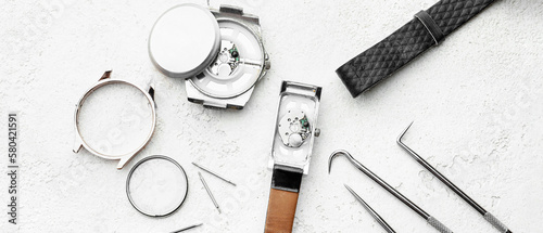 Bilde på lerret Broken watches and tools for repair on light background