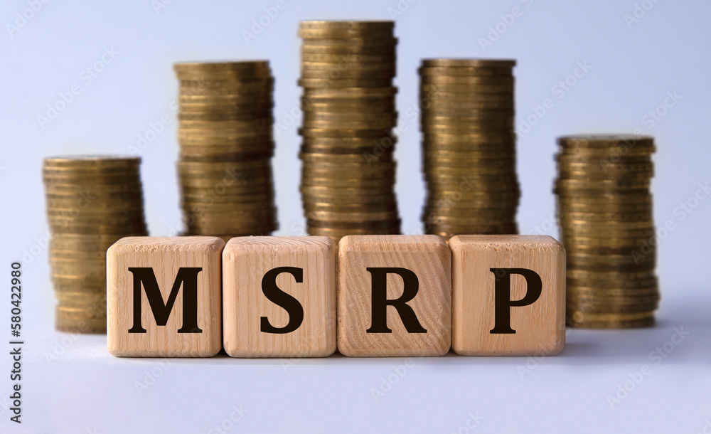 MSRP - acronym on wooden cubes on the background of stacks of coins MSRP - acronym on wooden cubes on the background of stacks of coins