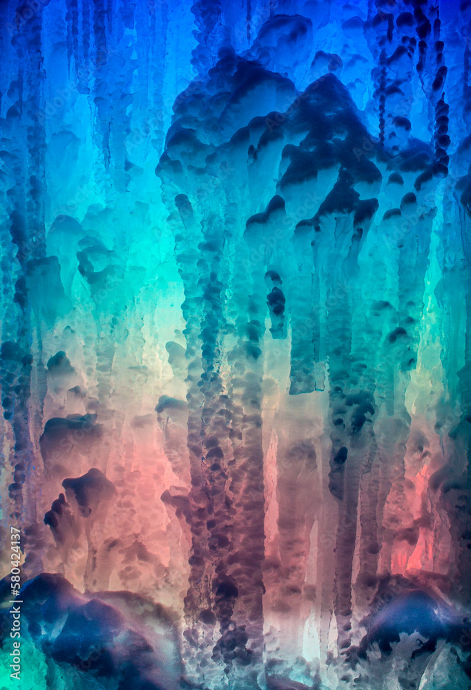 Abstract of colored light behind ice flow offers intriguing background