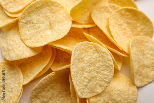 Delicious potato chips on white background  closeup