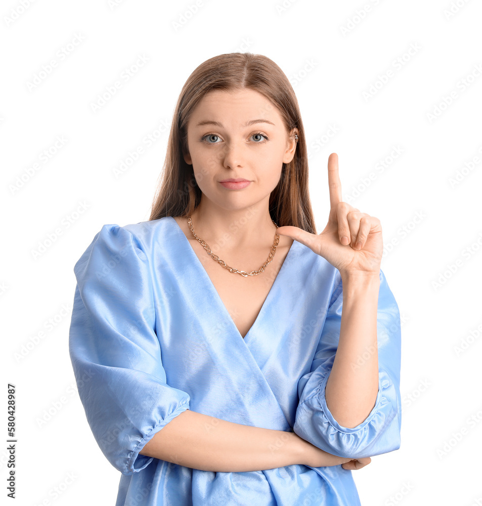 Young woman in dress showing loser gesture on white background Young woman in dress showing loser gesture on white background