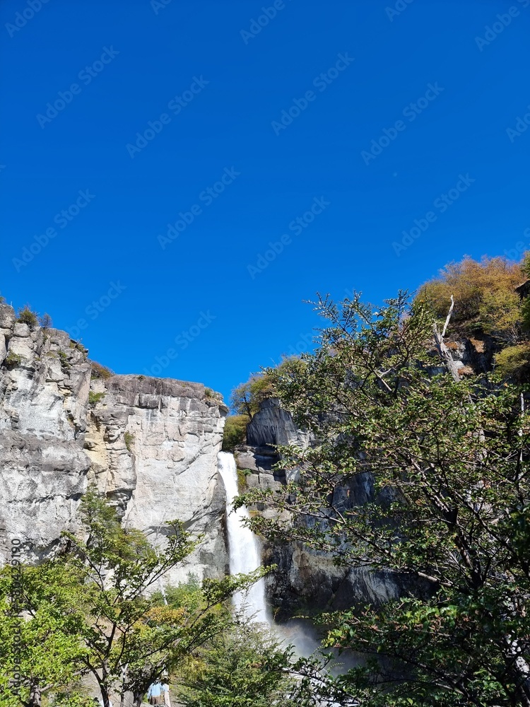 waterfall in the mountains, blue sky