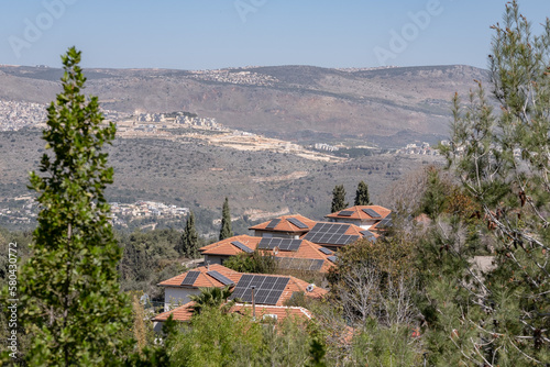 photovoltaic solar panels installed on the roof of residential homes in the village. harnessing the sun's solar energy to produce electricity for residential homes.                                    