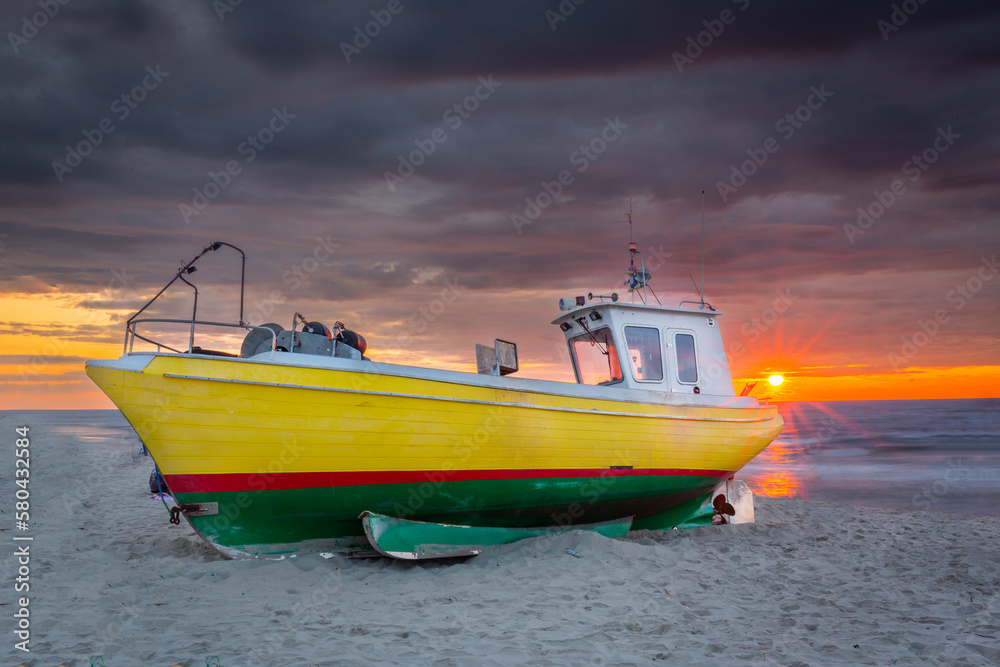 Fishing vessel against the backdrop of a beautiful sunset