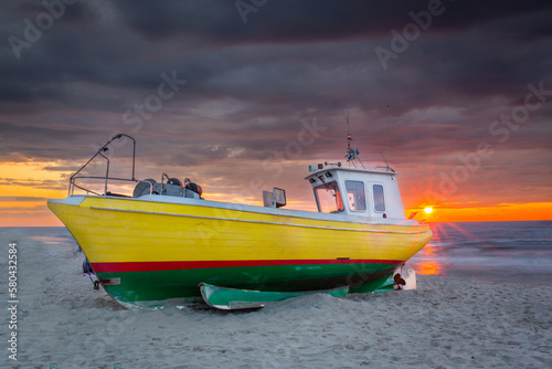 Fishing vessel against the backdrop of a beautiful sunset