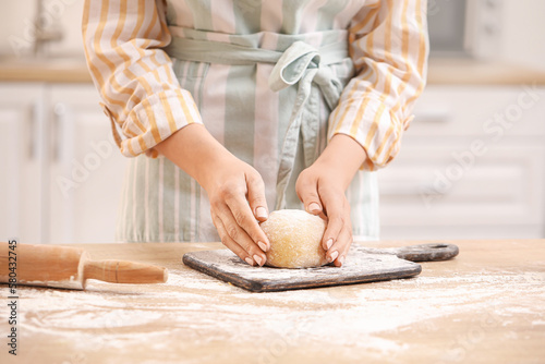 Woman preparing dough for pasta at table in kitchen  closeup