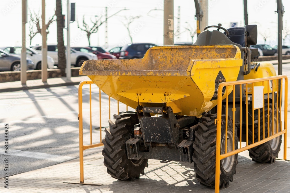 Tractor for the maintenance and repair of the asphalt and pavements of a street in a large city. Heavy machinery and construction equipment for road grading.