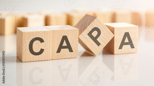 text CAPA on wooden blocks, background have blur effect