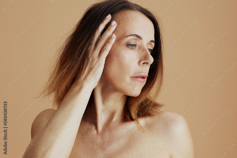Obraz premium modern 40 years old woman with short hair on beige background