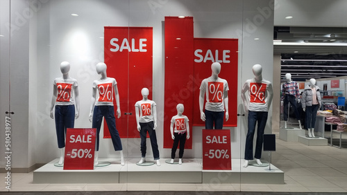 mannequins and the inscription sale on the shop window.  © andrey