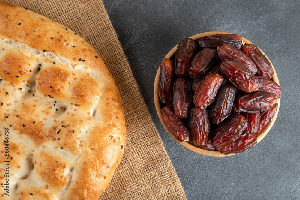 Date fruits with Ramadan pita on black background Date fruits with Ramadan pita on black background