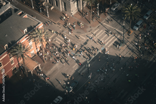 Aerial shots of pedestrians streaming across canal street, new Orleans, in the early evening sun after a parade 