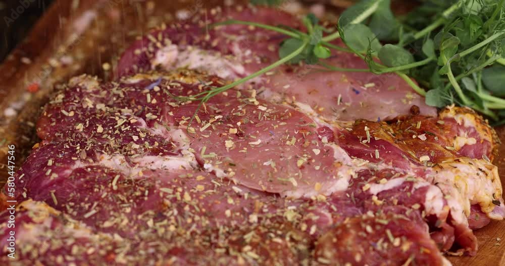 Sprinkle fresh pork meat with a mix of spices for meat , preparing pork neck meat for cooking during camping Sprinkle fresh pork meat with a mix of spices for meat , preparing pork neck meat for cooking during camping
