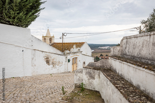 a cobbled street close to the Church of Saint Mary of the castle in Alcácer do Sal, district of Setúbal, Alentejo, Portugal - December 2022