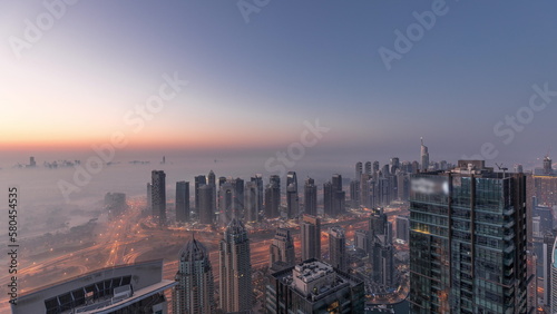 Panorama of Dubai Marina with JLT skyscrapers and golf course night to day timelapse  Dubai  United Arab Emirates.