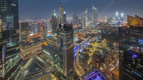 Panorama of futuristic skyscrapers after sunset in financial district business center in Dubai day to night timelapse © neiezhmakov