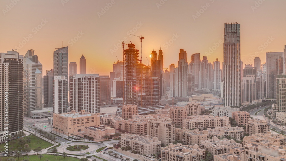 Dubai's business bay towers at sunset aerial timelapse. Rooftop view of some skyscrapers