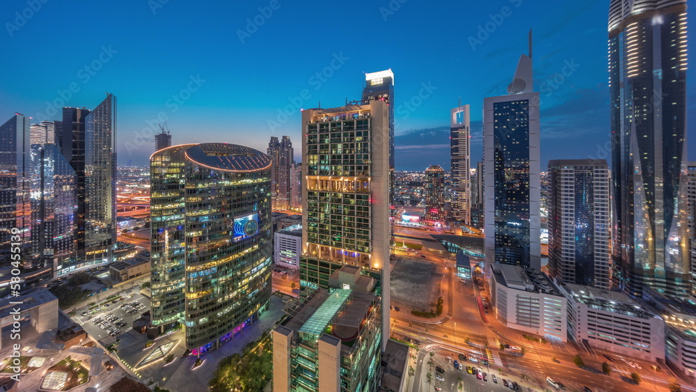 Naklejka premium Dubai international financial center skyscrapers aerial day to night timelapse.