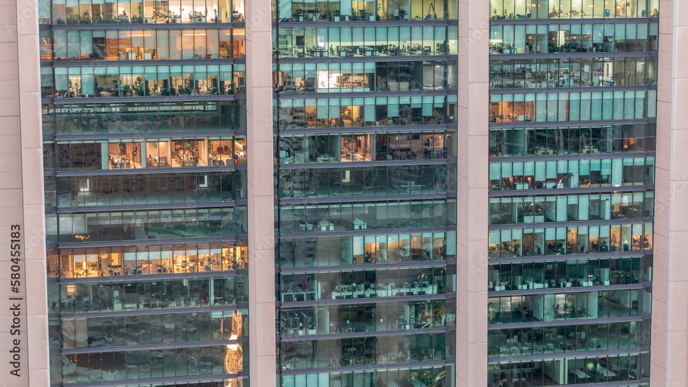 Big glowing windows in modern office and residential buildings day to night timelapse