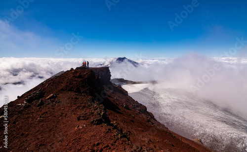 Vista del volcán Tolhuaca y montañistas amigos entre las Nubes desde la cumbre del volcán Lonquimay, region de la Araucanía, Chile photo
