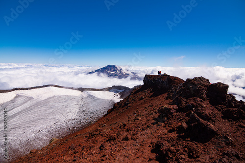 Hermosa Vista del volcán Tolhuaca entre las Nubes desde la cumbre del volcán Lonquimay, region de la Araucanía, Chile photo