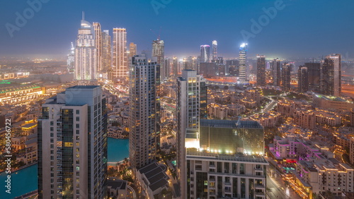 Aerial view of a big futuristic city day to night timelapse. Business bay and Downtown