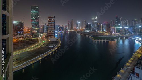 Photography Cityscape of skyscrapers in Dubai Business Bay with water canal aerial night tim