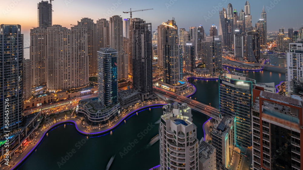 Obraz premium View of various skyscrapers in tallest recidential block in Dubai Marina aerial day to night timelapse