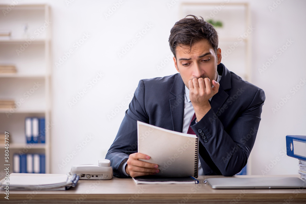 Young male employee working in the office Young male employee working in the office