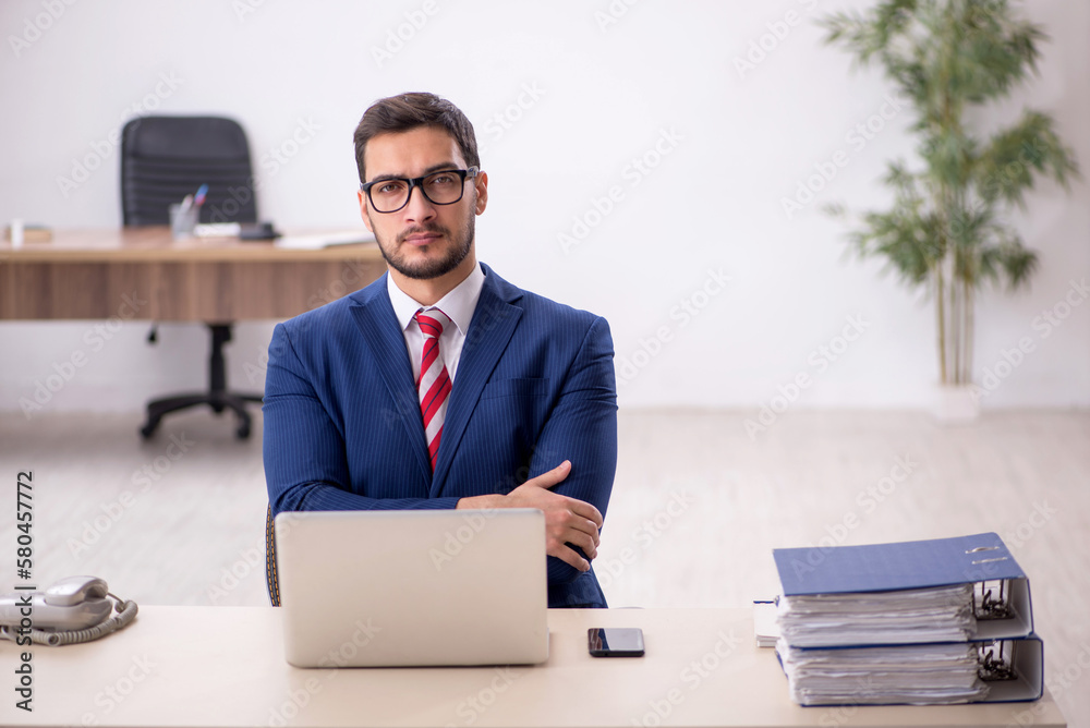 Young male employee working in the office Young male employee working in the office