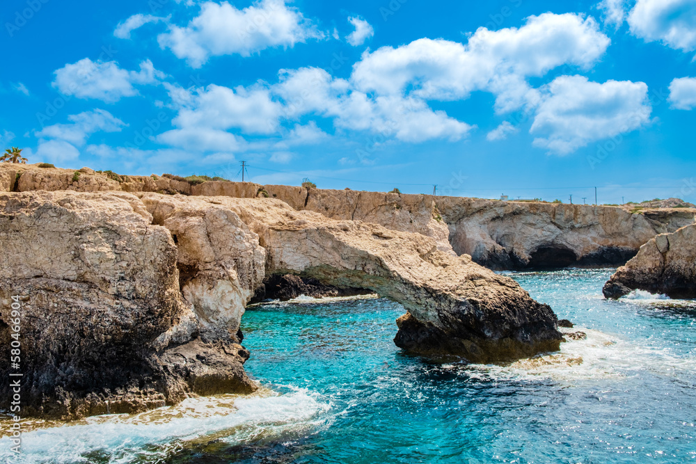 Love bridge near Ayia Napa in Cyprus, view from water. Natural rock arch formation Bridge of Lovers at Cape Greco. Sea caves on coastline between Agia Napa and Cavo Greco National park
