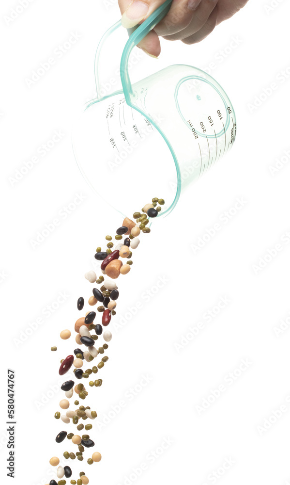 Mix beans fall down explosion, several kind bean float pouring in measured cup. Dried white