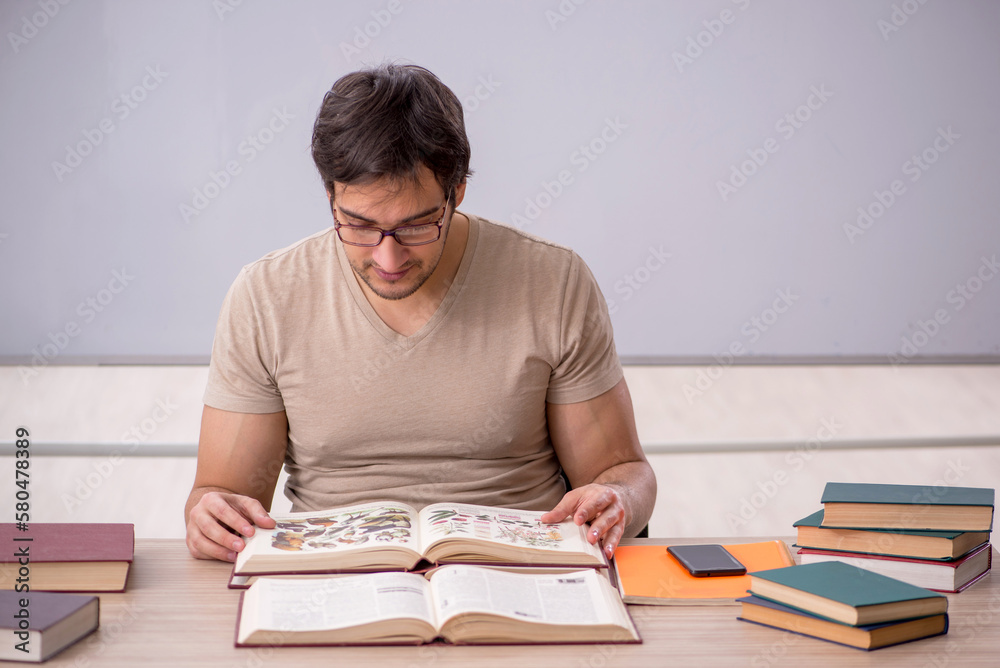 Young male student sitting in the classroom Young male student sitting in the classroom