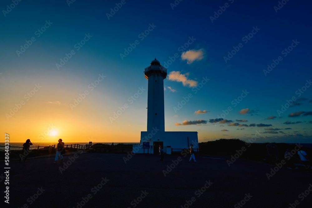 Sunrise and seascape from a cape on Miyakojima with a lighthouse