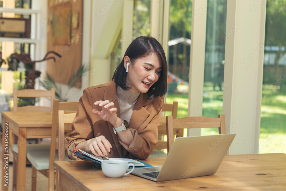 Woman typing laptop computer online meeting at home office work from home. Asian business woman using notebook laptop lifestyle. Happy programmer woman typing keyboard laptop read online website Woman typing laptop computer online meeting at home office work from home. Asian business woman using notebook laptop lifestyle. Happy programmer woman typing keyboard laptop read online website