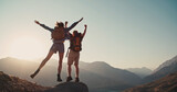 Travel concept with happy couple at mountain top with raised arms and islands at background. Place for text. 