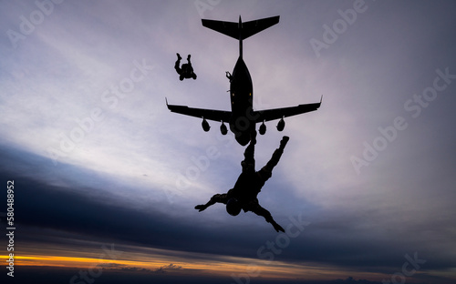 Skydivers jumping during Sunset