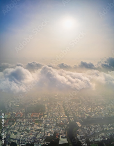 Aerial view of Saigon cityscape at morning with misty sky in Southern Vietnam. Urban development texture  transport infrastructure and green parks