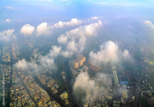 Aerial view of Saigon cityscape at morning with misty sky in Southern Vietnam. Urban development texture  transport infrastructure and green parks