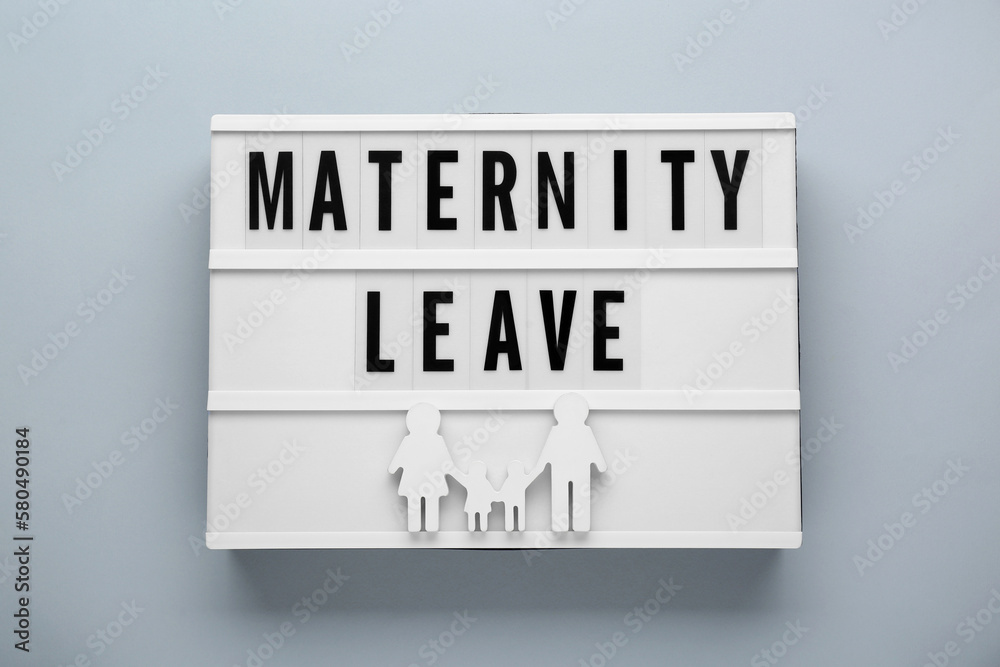 Lightbox with words Maternity Leave and figures of family on light grey background, top view Lightbox with words Maternity Leave and figures of family on light grey background, top view