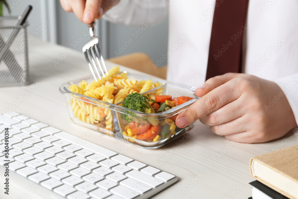 Office employee having business lunch at workplace, closeup Office employee having business lunch at workplace, closeup